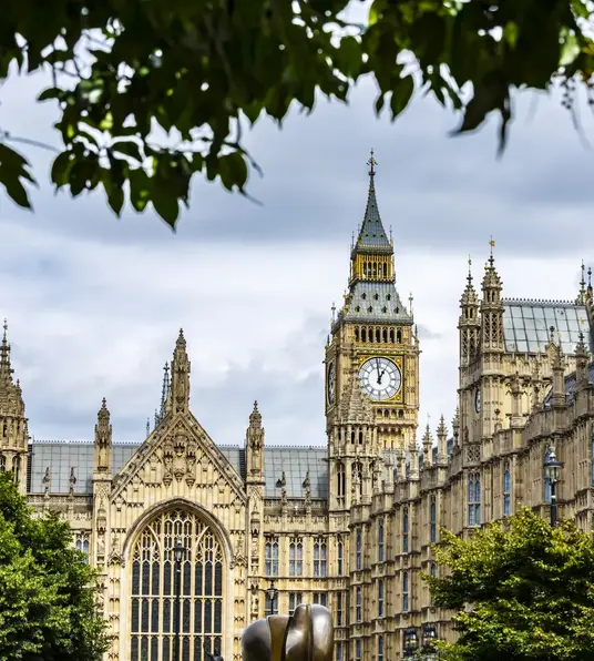 a clock tower in front of a large building