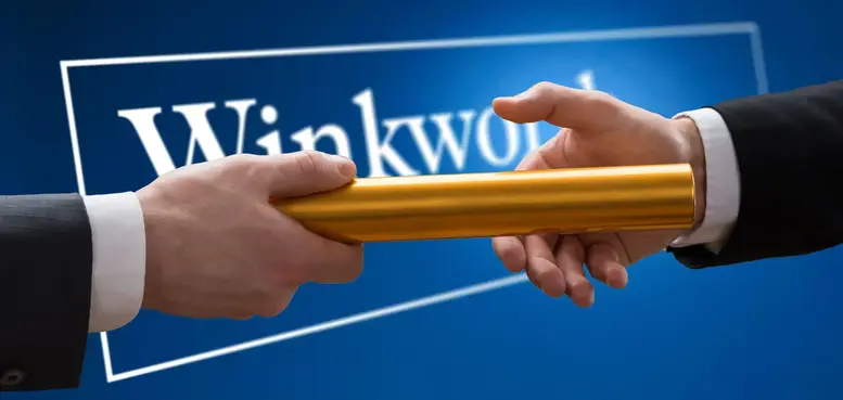 a close-up of hands holding a gold bar