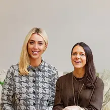 two women sitting in a chair