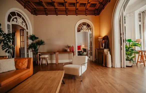 a room with a wood floor and a white chair