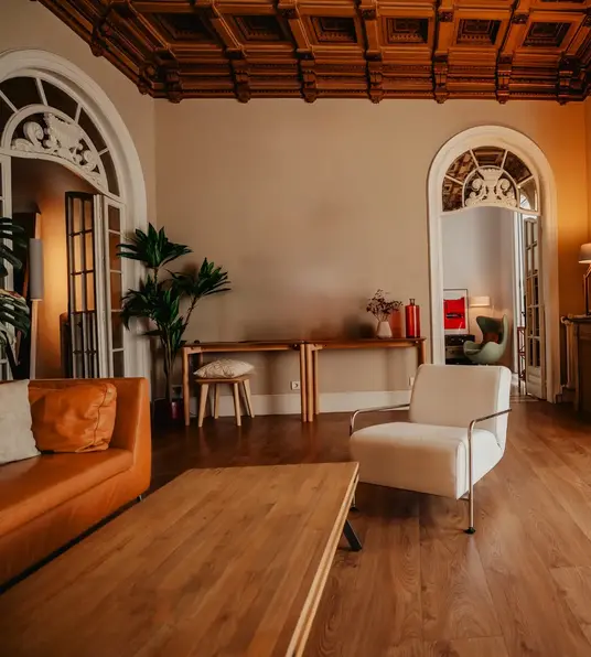 a room with a wood floor and a white chair