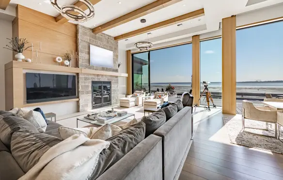 a living room with a large window overlooking the ocean