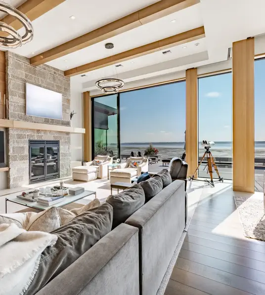 a living room with a large window overlooking the ocean