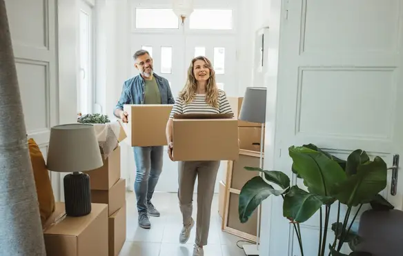 a man and woman carrying boxes