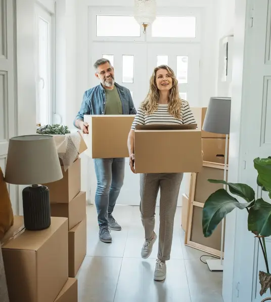 a man and woman carrying boxes