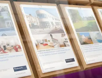 a group of posters on a shelf