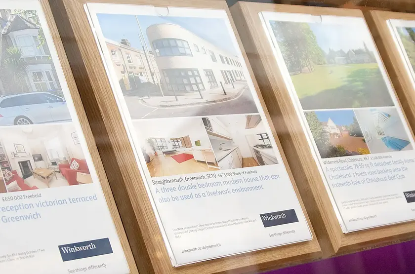 a group of posters on a shelf