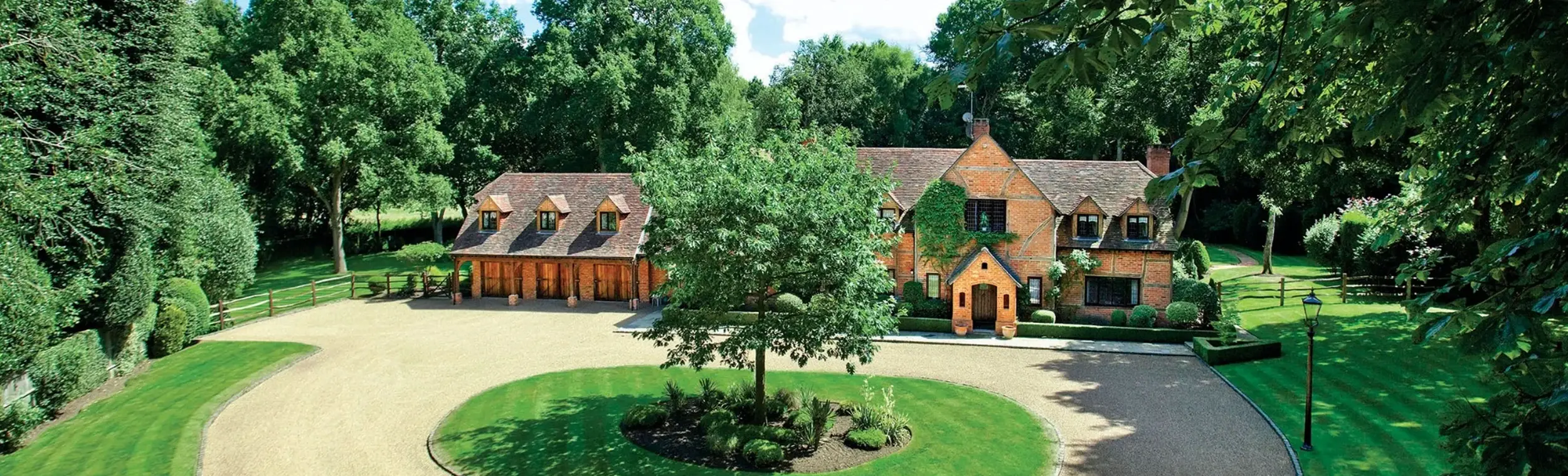 a house with a large lawn and a tree