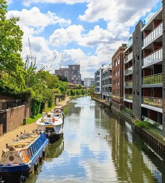 a canal with boats and buildings