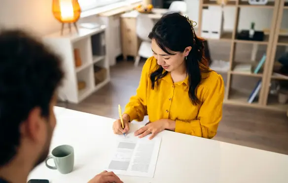 a woman signing a document