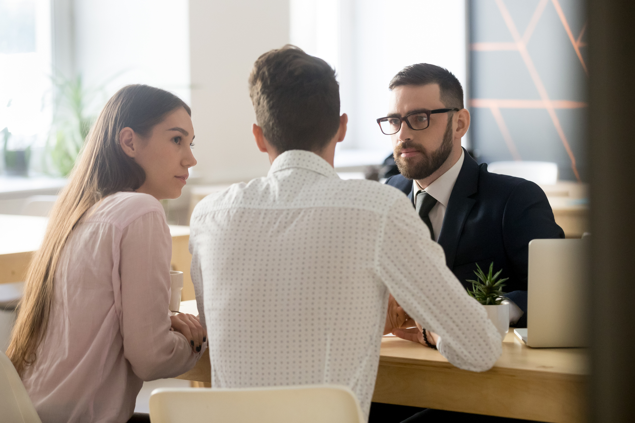 Couple-discussing-offer-with-agent